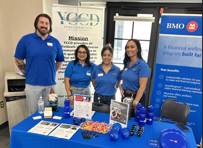 group photo of BMO staff behind their table