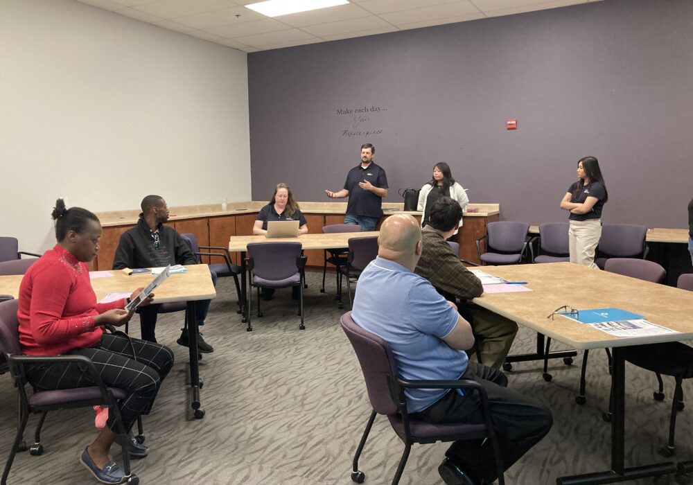 Sac Sewer representative speaking to a group of four job seekers.