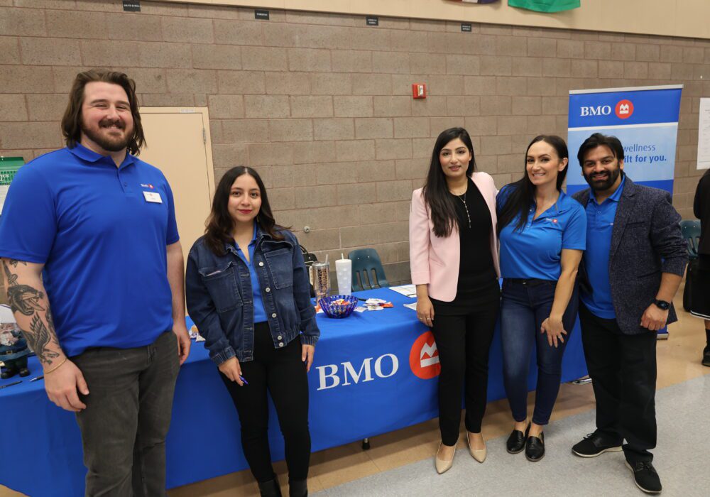 Group photo of BMO staff in front of their table