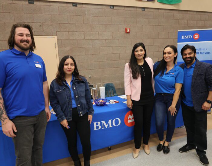 Group photo of BMO staff in front of their table