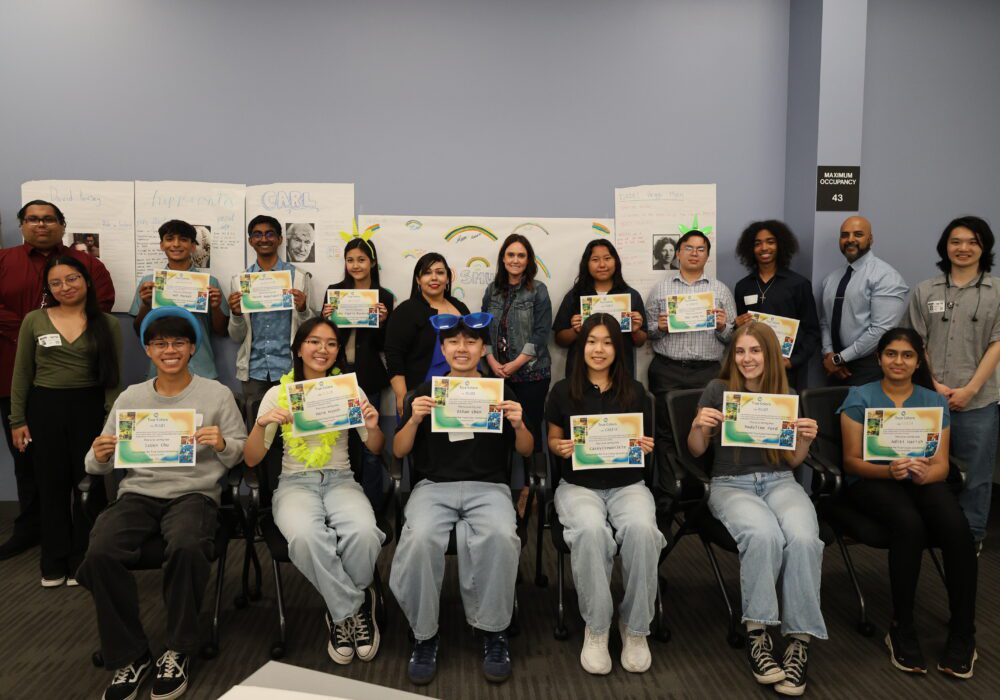 Photo of 12 SMUD interns holding up their True Colors certificate with staff
