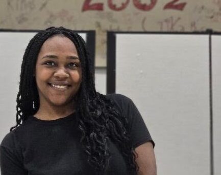 Mohagany in front of a mural